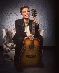 Photo of Christie Lenée with guitar