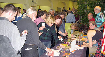 Photo of people at a concert buying CDs